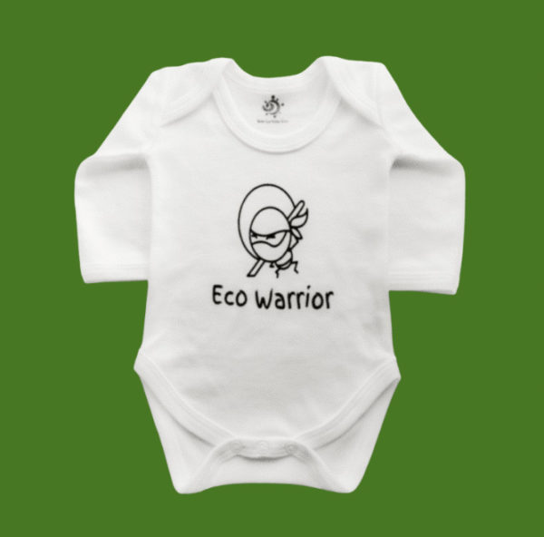 White baby long sleeve bodysuit with the words Eco Warrior and a picture of a ninja warrior printed on the front set on a green background